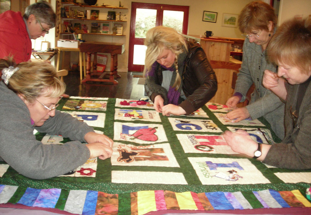 Women engrossed in finishing off the Alphabet Quilt.  (Photo: Deborah Stockdale)