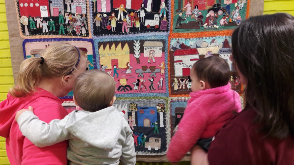 Viewers - of all ages - absorbed in the arpillera 