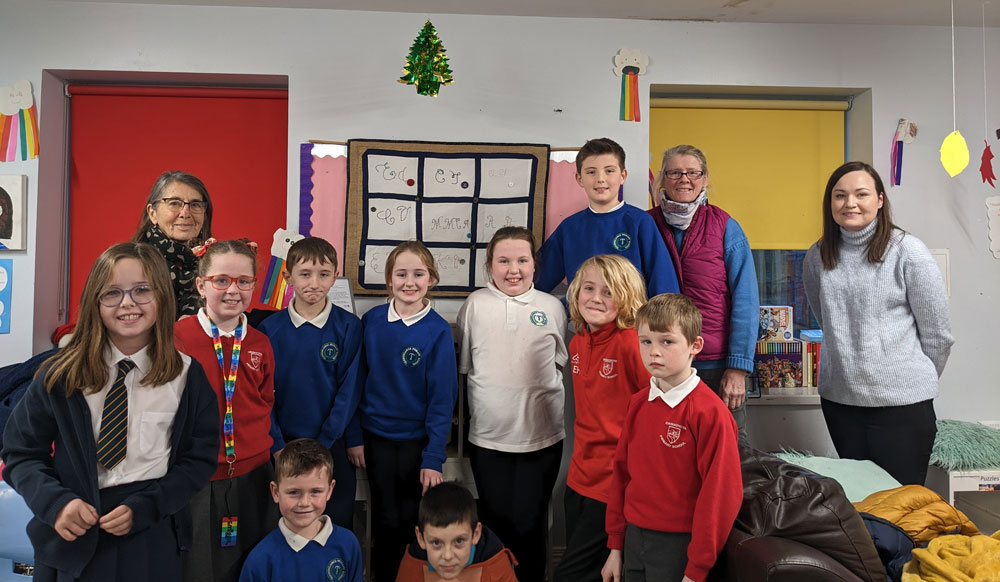 Children from LCDI Afterschool club, proudly pose with their collective textile 