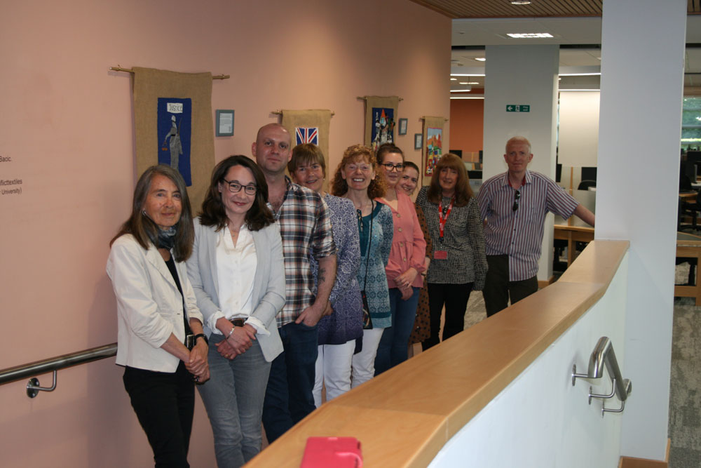 Personnel from ARK, Conflict Textiles, Queen's University Belfast  and invited guests pictured at the launch of the inaugural 'ARK/Conflict Textiles' exhibition, McClay Library, QUB, 1 June 2023. (Photo: Mike McCool)
